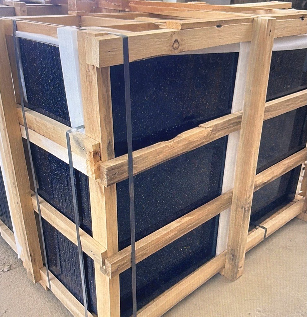 Black Galaxy granite slabs packed vertically in export wooden crate with foam protection